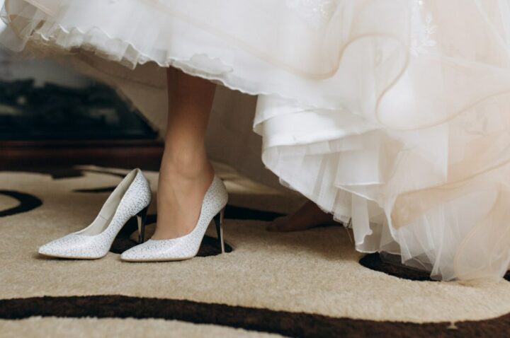 a bride in her wedding shoes on high heels