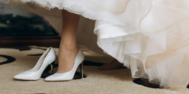 a bride in her wedding shoes on high heels
