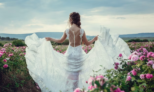 Bride in a wedding dress among flowers