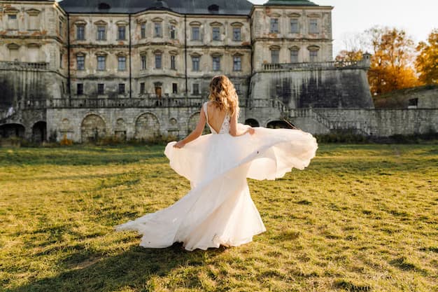 A bride in a wedding dress spins against the backdrop of a castle