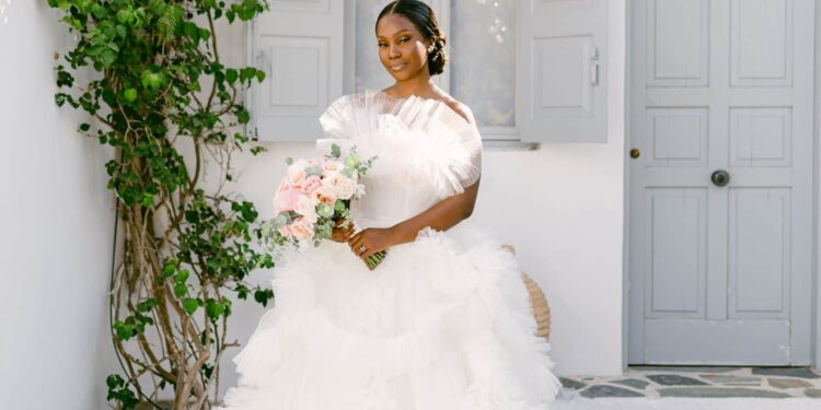 A bride in a white dress with a bouquet in her hands