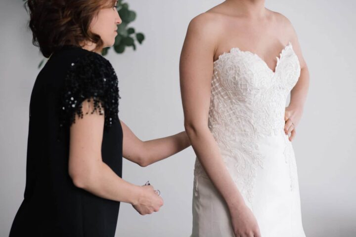 A bride tries on a dress for her wedding