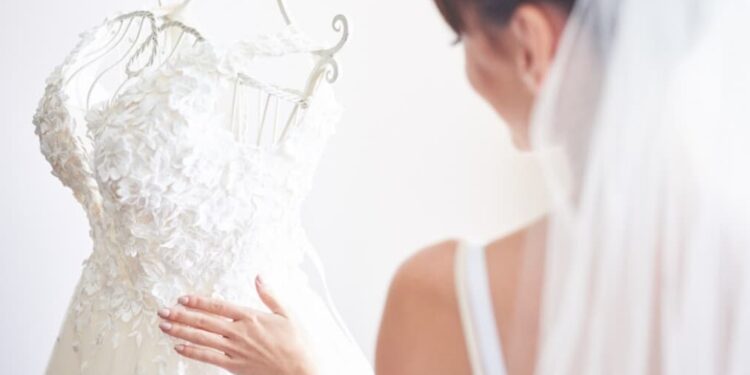 A lineup of wedding dresses on mannequins in a bright showroom