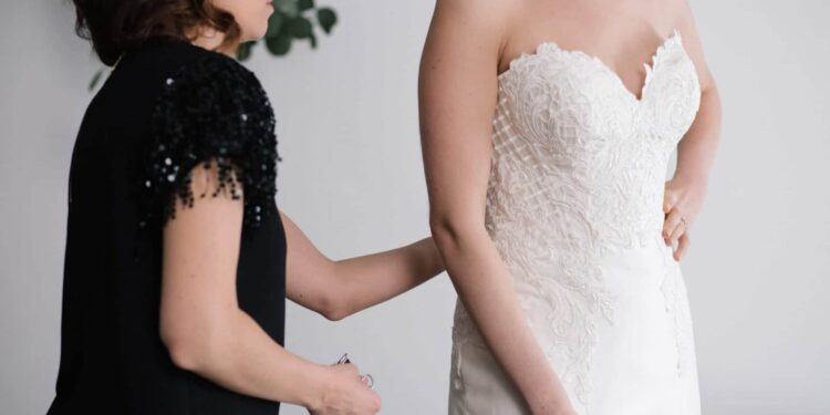 A bride tries on a dress for her wedding